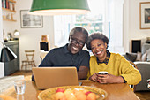 Portrait senior couple using laptop