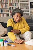 Senior woman checking blood pressure