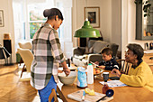 Grandmother watching granddaughter baking