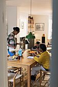Grandmother and grandchildren baking at dining table