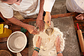 Overhead view chefs making pizza dough flour nest