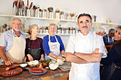 Portrait chef with senior students kitchen