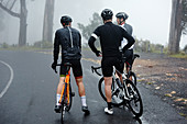 Male cyclist friends taking a break