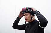 Focused male cyclist with helmet and goggles