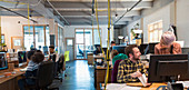 Creative business people working in open plan office