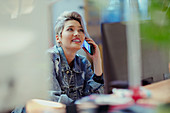 Creative businesswoman talking on smart phone