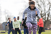 Focused, determined woman exercising in park