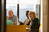 Smiling senior business people in conference room meeting