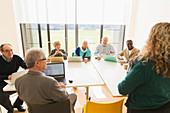 Senior business people using digital tablets and laptops