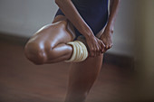 Strong, young female dancer stretching leg