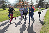 Runners running ins sunny park
