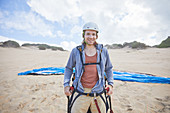 Portrait male paraglider on beach