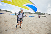 Female paraglider taking off