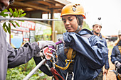 Woman preparing zip line equipment