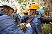 Friends preparing zip line equipment