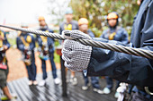 Woman in glove holding zip line