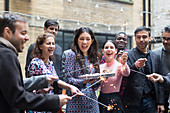 Woman holding birthday cake among friends