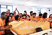 Hackers with banner coding at hackathon