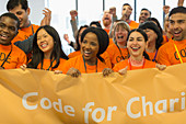 Happy hackers with banner coding at hackathon