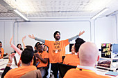 Exuberant hackers cheering, coding at hackathon