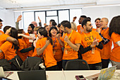 Happy hackers celebrating, coding at hackathon