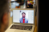 Businessmen video conferencing on laptop