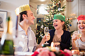 Happy family in paper crowns at Christmas dinner