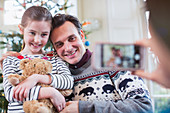 Father and daughter posing for photograph