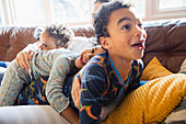 Young family in pyjamas on sofa