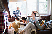 Multi-ethnic young family in pyjamas playing