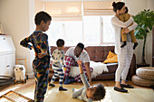 Young family in pyjamas playing and relaxing