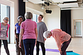 Active seniors talking after exercise class