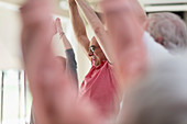 Active senior man stretching arms overhead