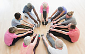 Active seniors stretching legs in circle