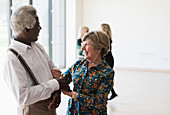 Active senior couple dancing in dance class