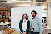 Portrait business people at whiteboard in office
