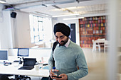 Indian businessman in turban using smart phone