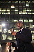 Businessman standing below highrise