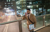 Businessman, walking on bridge at night