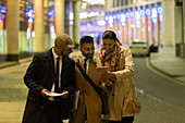 Business people using digital tablet at night