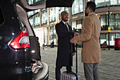 Businessmen with suitcase handshaking