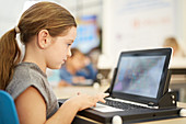 Girl playing game on laptop