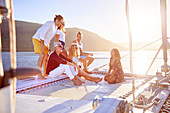 Friends relaxing on sunny catamaran