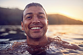 Close up portrait carefree man swimming in ocean