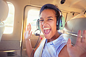 Portrait of young woman riding in airplane