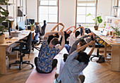 Creative business people practicing yoga