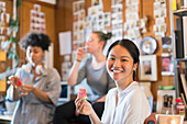 Portrait creative businesswoman eating watermelon