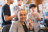 Portrait creative businesswoman eating watermelon