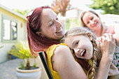 Affectionate mother and daughter on patio