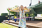 Portrait playful girl playing with plastic hoop